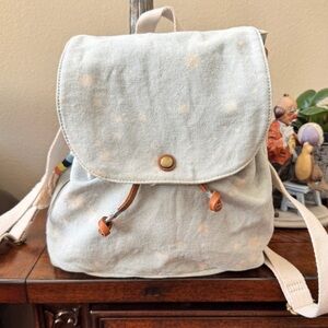 “TOMS” Faded Jeans with Leather Pull Trim Backpack with Relaxed Structure